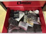 a red tool box filled with assorted items on the floor