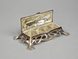 a small silver box with a mirror on top of it