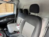 two seats in the back of a van with a steering wheel