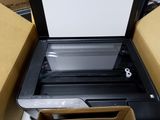 a printer that is sitting in a box on the floor