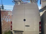a white van that is parked in front of a building