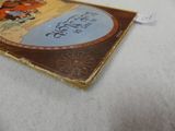 a book on the bed with a tag on it