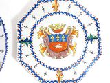 two plates that have a coat of arms on them