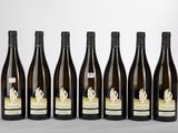 six bottles of wine are lined up in a row