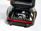 a small toy car with a small engine in the trunk