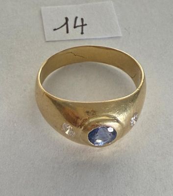 an image of a gold ring with a blue stone on it