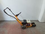 a small lawn mower that is sitting on the floor