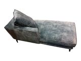 grey leather chaise lounger with two pillows on it