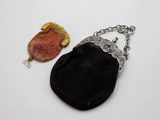 une image représentant un sac à main noir et un sac à main marron posés sur une surface blanche