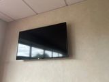 a flat screen tv mounted on the wall in a room