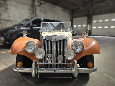 une voiture orange et blanche garée dans un garage