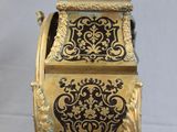 a gold and black clock sitting on a table