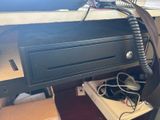 an image of a computer desk with a drawer and a phone