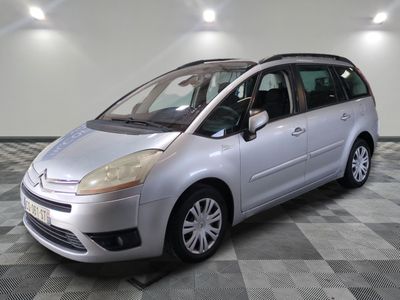 a picture of a silver minivan parked in a garage