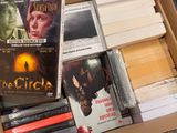 a lot of dvds in a box on the floor