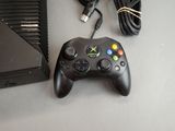 a video game controller and a charger sitting on a table
