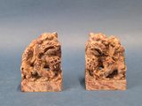 pair of chinese carved wood bookends of a dragon and a lion