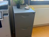 a desk with a printer and a printer on it