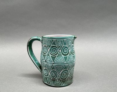 a close up of a cup with a pattern on it