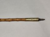 an image of a wooden stick with a metal handle