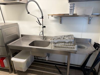 a kitchen with a sink and a dishwasher in it