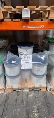 many buckets of paint on the shelf in the store