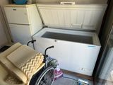a wheelchair that is sitting in front of a freezer