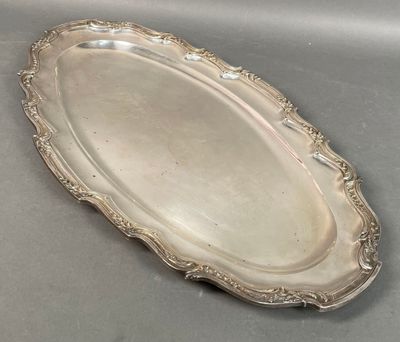 an oval silver tray with a decorative design on the edge