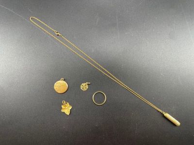 un gros plan sur un collier, une bague et d'autres objets posés sur une table