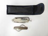 a knife, a pocket knife, and a keychain on a white surface