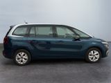 the blue and white car is parked in a parking lot
