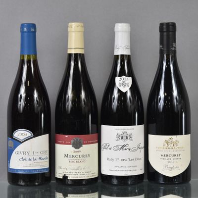 several bottles of wine are lined up on a glass table