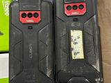 two cell phones that are sitting on top of a box