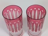 pair of pink glass vases on a white surface