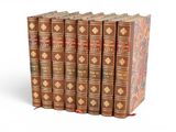 six old books are stacked on top of each other on a white surface