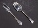 two spoons and a fork on a table