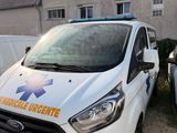 a white van that is parked in front of a building