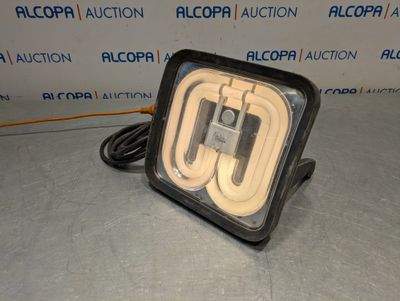a close up of a light on a table in front of a wall