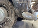 a close up of a car tire with a hole in the tire