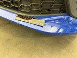 a close up of a car ' s front bumper with a sticker on it