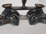 a silver candle holder with two candles on it