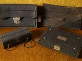 three black leather cases sitting next to each other on a table
