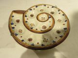 a white bowl with a blue and yellow design on it