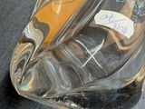 a clear glass shoe with a label on it