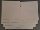 several papers are stacked on top of each other on a table
