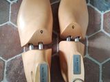 pair of tan leather shoes sitting on top of a tiled floor