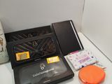 a black box with a wallet and other items on a table