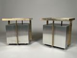 a pair of stainless steel and wood side tables