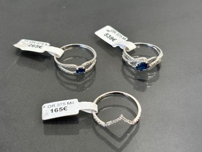 trois bagues munies d'étiquettes, posées sur une table