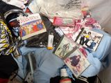 a pile of clothing and other items on a bed